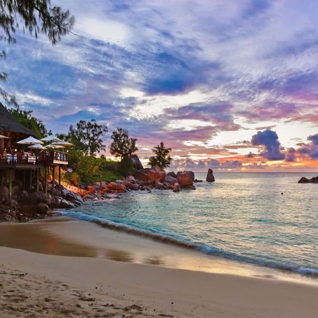 Beach with terrace restaurant at sunset 