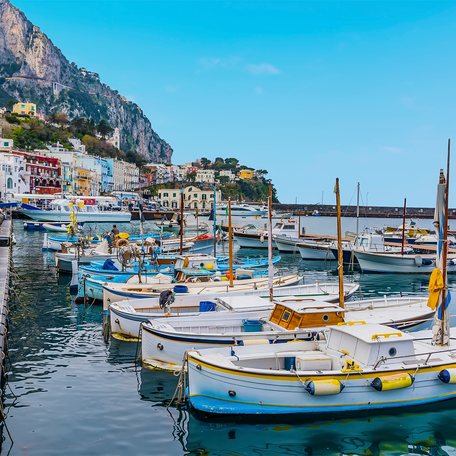 A small marina on the Amalfi Coast with multiple boat charters berthed