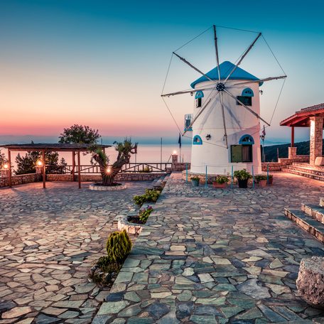 Rear view of a Cycladic windmill facing the sea at sunset