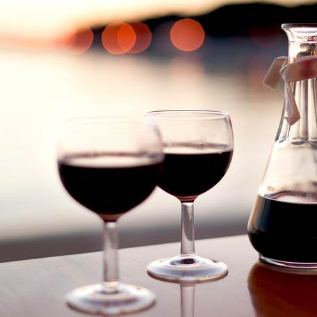 A carafe of red wine and two glasses