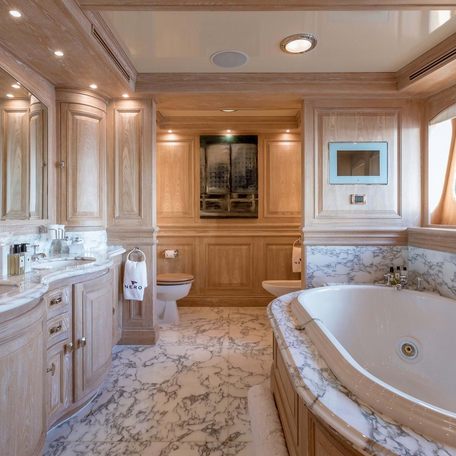 Master cabin bathroom onboard charter yacht NERO, bath to starboard and sink to port.