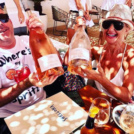 Charter guests at the Shellona Beach Club posing with three-liter magnums