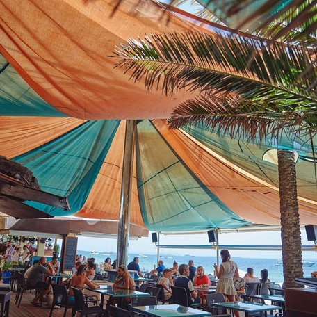 Colorful canopies keep the outdoor dining area shaded 