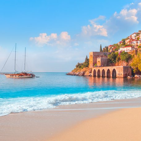 Alanya coastline in Turkey, with a gulet yacht charter at anchor in the bay
