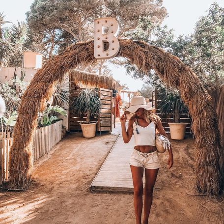 Female charter guest standing at the entrance to Beso Beach Ibiza