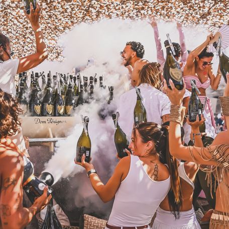 Charter guests at Verde Beach with champagne