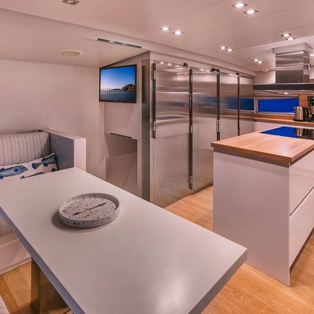 Overview of the galley and adjacent dinette onboard charter yacht ISLANDER II 