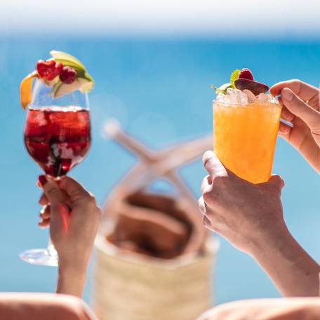 Charter guests holding up cocktails at Byblos Beach