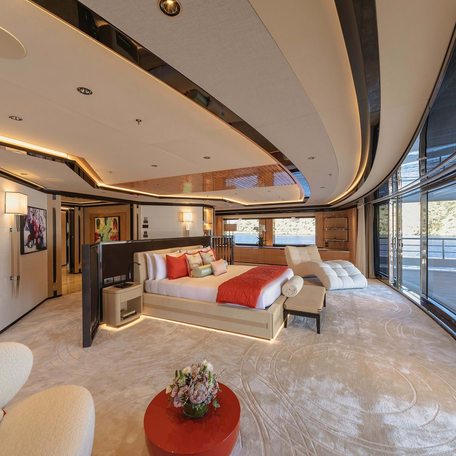 Master cabin onboard Charter yacht PROJECT X, central berth facing forward with full-beam wall of windows opposite.