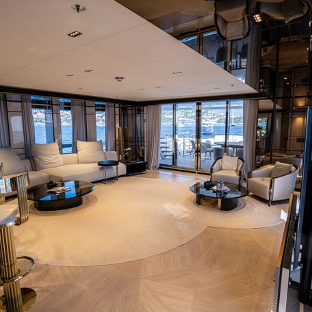 Lounge area onboard charter yacht RELIANCE, cream seating facing a wall mounted TV