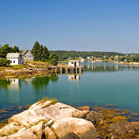 A view of a private homes and a fishing shack on a dock near a scenic fishing village on beautiful and quaint Swans Island, Maine.