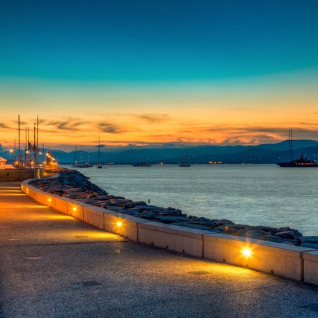 Deserted promenade along coast of St Tropez at sunset