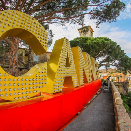 Large yellow sign with lights reading Cannes during the Cannes Film Festival