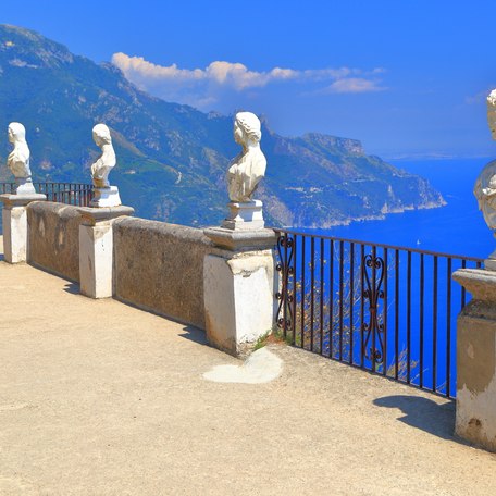 A line of bust sculptures along a raised viewpoint on the Amalfi Coast