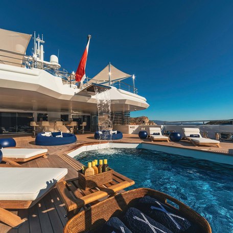 Overview of the swimming pool and sun loungers onboard charter yacht PROJECT X
