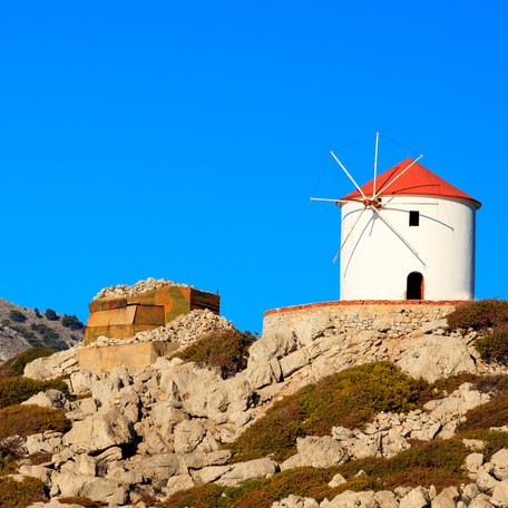 A Cycladic windmill on top of a hill in the Cyclades Islands