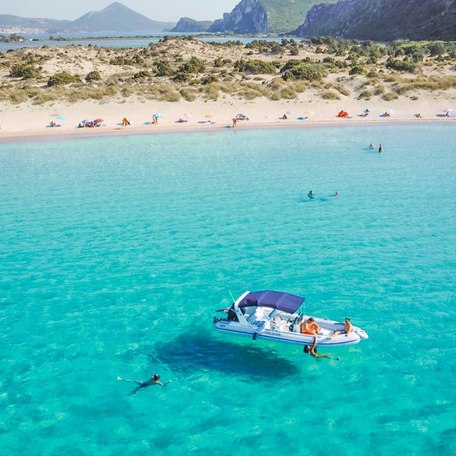 Visitors enjoy the clear waters and white sands of the bay 