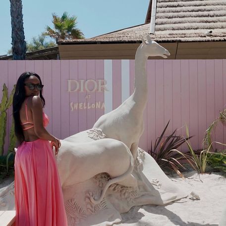 A charter guest poses with sand sculptures outside the Shellona Beach Club