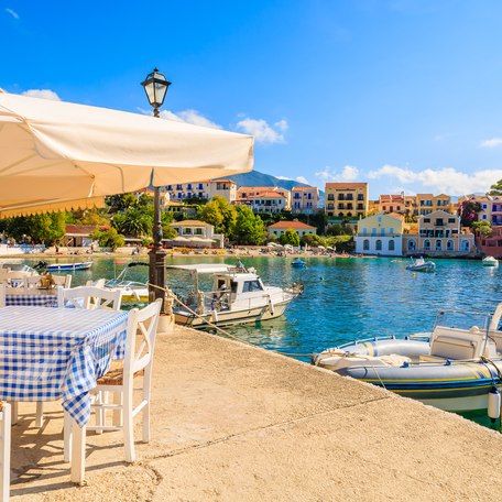A waterside cafe with tenders berthed adjacent in the Mediterranean