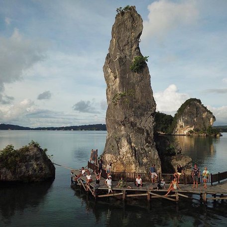 People standing on the wooden walkway that goes round the Batu Pensil formation 