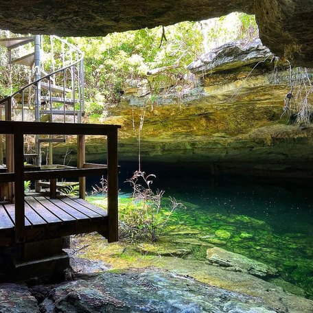 Wooden staircase and jetty leading down to waters edge in the cave 