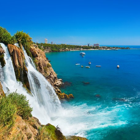 Overview of a beautiful waterfall along the coastline of Greece.