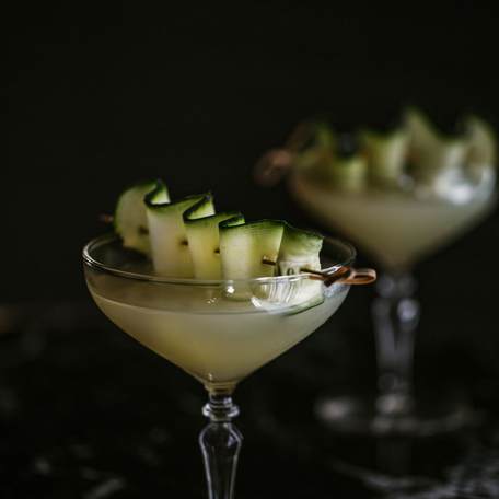 Elegant cocktail with cucumber garnish from La Gaia's bar 