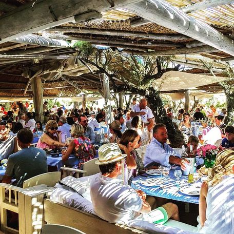 Le Club 55 filled with guests at tables
