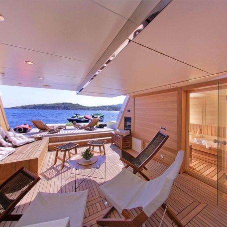 Overview of the beach club onboard charter yacht GRANDE AMORE, seating area looks out through open transom with views of the sea. 