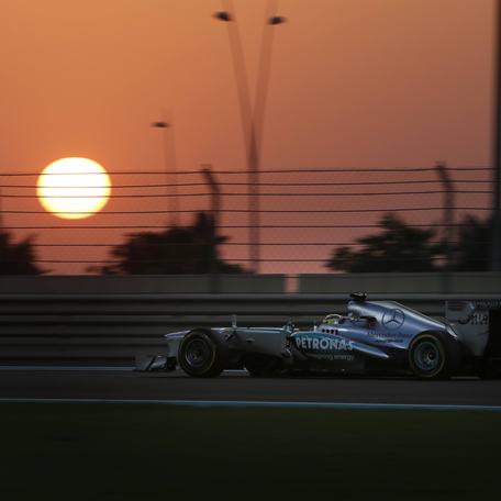 A Grand Prix racing car with a sunset in the background