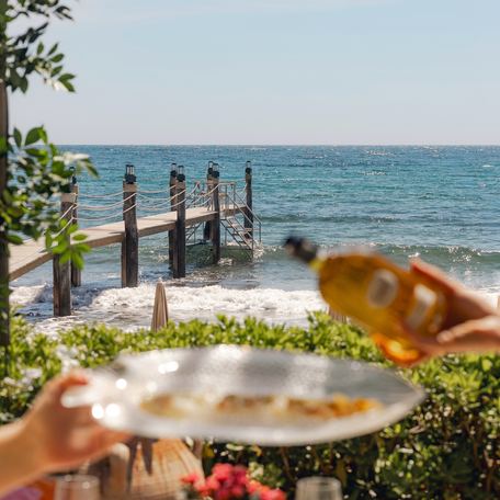 Jardin Tropezina with guests pouring from bottle