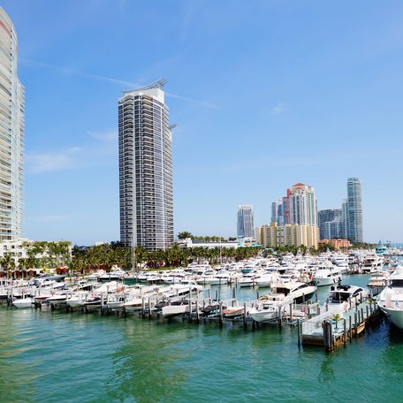 Water level view of a marina in Miami with skyscrapers in the background