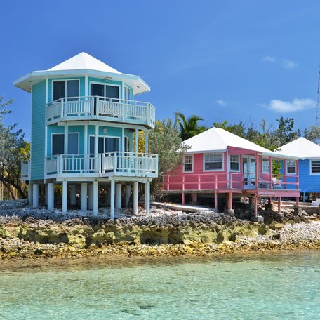 A line up of Bahamian buildings on the coast of an island 
