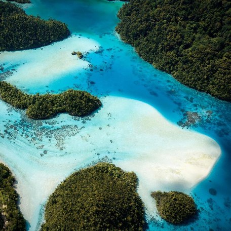 Aerial view of the lagoon's white sands and shallow, blue waters