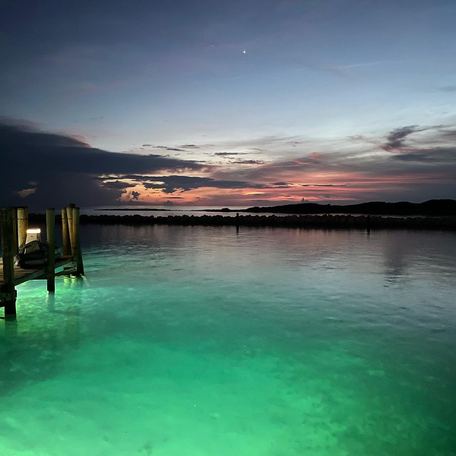 Cay's waters illuminated by lights at night time 