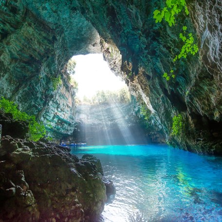 A sheltered cave with sunlight filtering in 