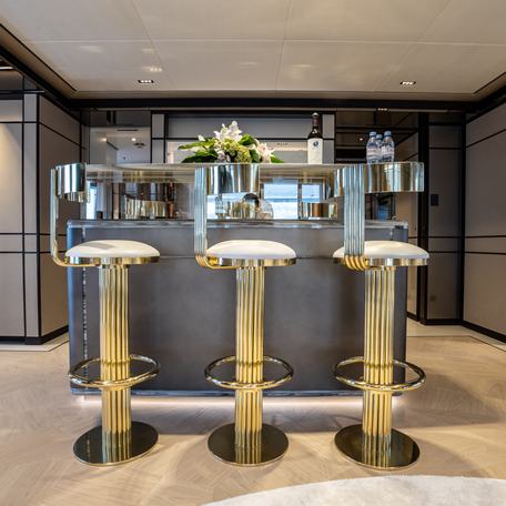 Overview of a wet bar onboard charter yacht RELIANCE, with three bar stools