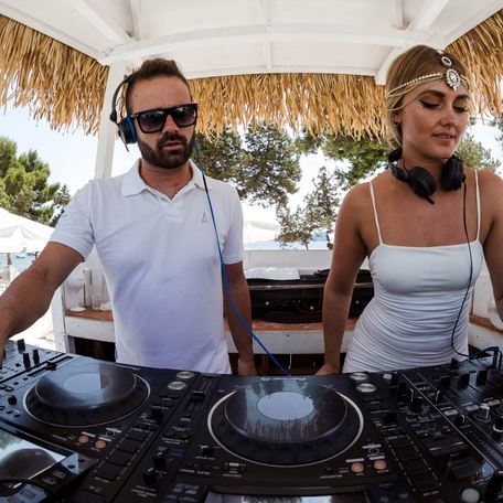 Man and woman using DJ deck