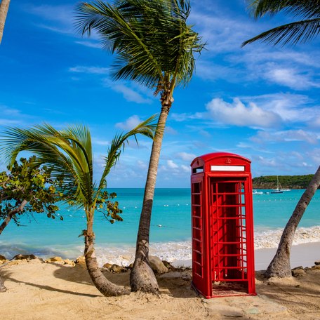 A red telephone box on a beach in the British Virgin Islands