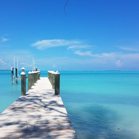 A pontoon reaching out to azure waters in the Bahamas