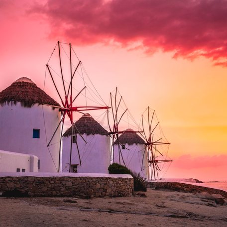 Line of Cycladic windmills on the island of Mykonos at sunset