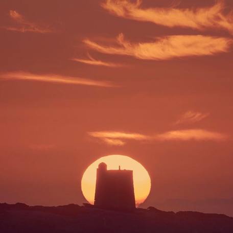 Ancient watchtower lit up by the sunset 