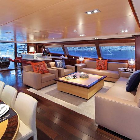 Main salon onboard charter yacht PRANA, lounge area with sofas facing each other.
