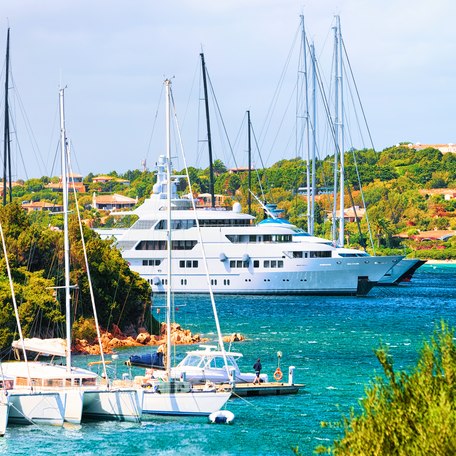 Superyacht charters at anchor in a Mediterranean bay