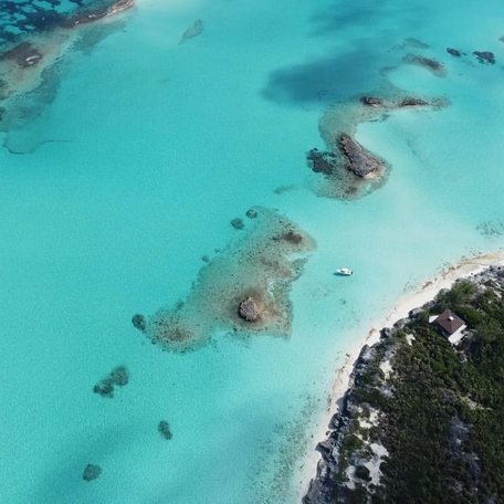 Aerial shot of the blue waters of Norman's Cay 