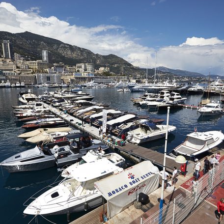 Overview of Port Hercule during the Monaco Grand Prix, with many motor yachts berthed in the marina