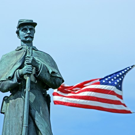 Civil War memorial statue with US flag