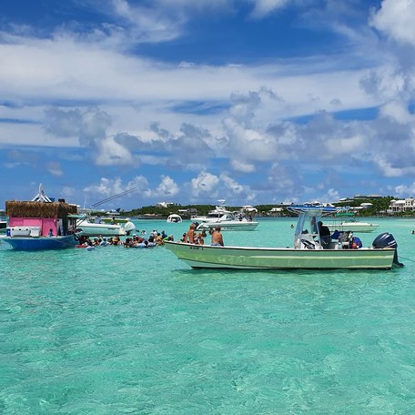 Sailing boats on turquoise water on a Great Guana Cay beach 