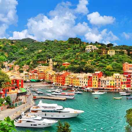 Overview of a marina and coastal town in the Italian Riviera, superyachts berthed in the marina
