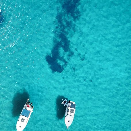 Visitors cruising in their yachts on Voidokilia's waters